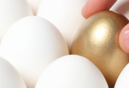 Golden egg amongst white eggs