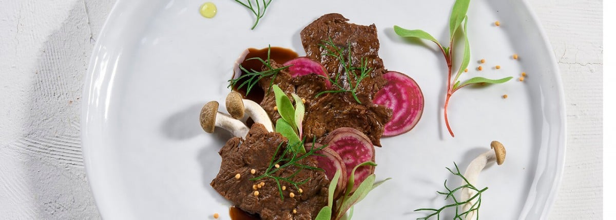 Plant-based meat with mushrooms and sliced radishes