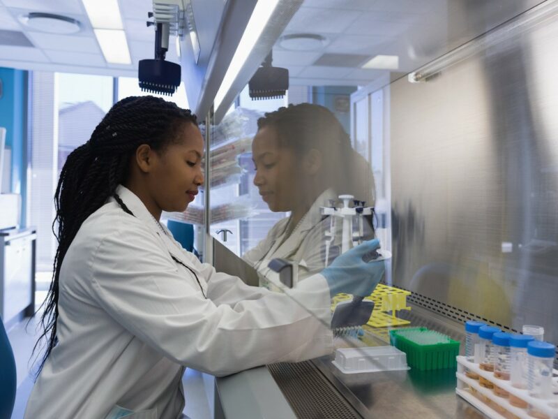 Scientist filling test tubes