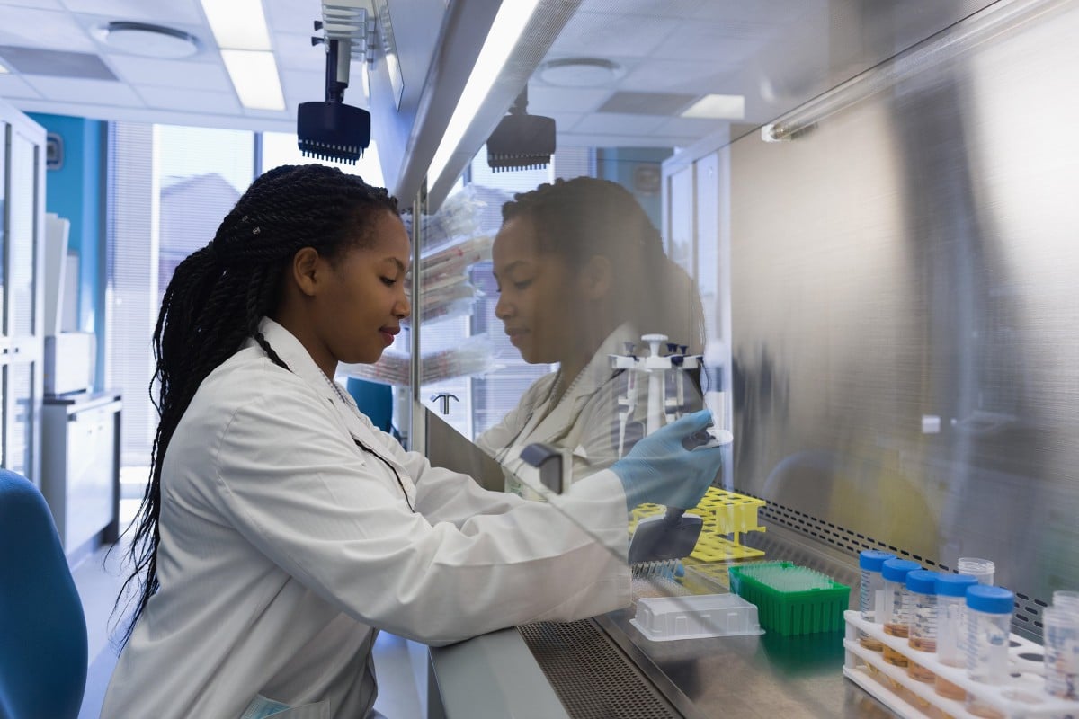 Scientist filling test tubes