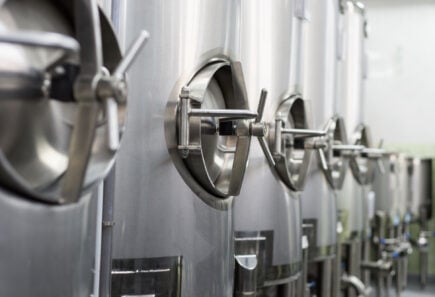 Steel fermentation tanks, representing bioreactors for cultivated meat production