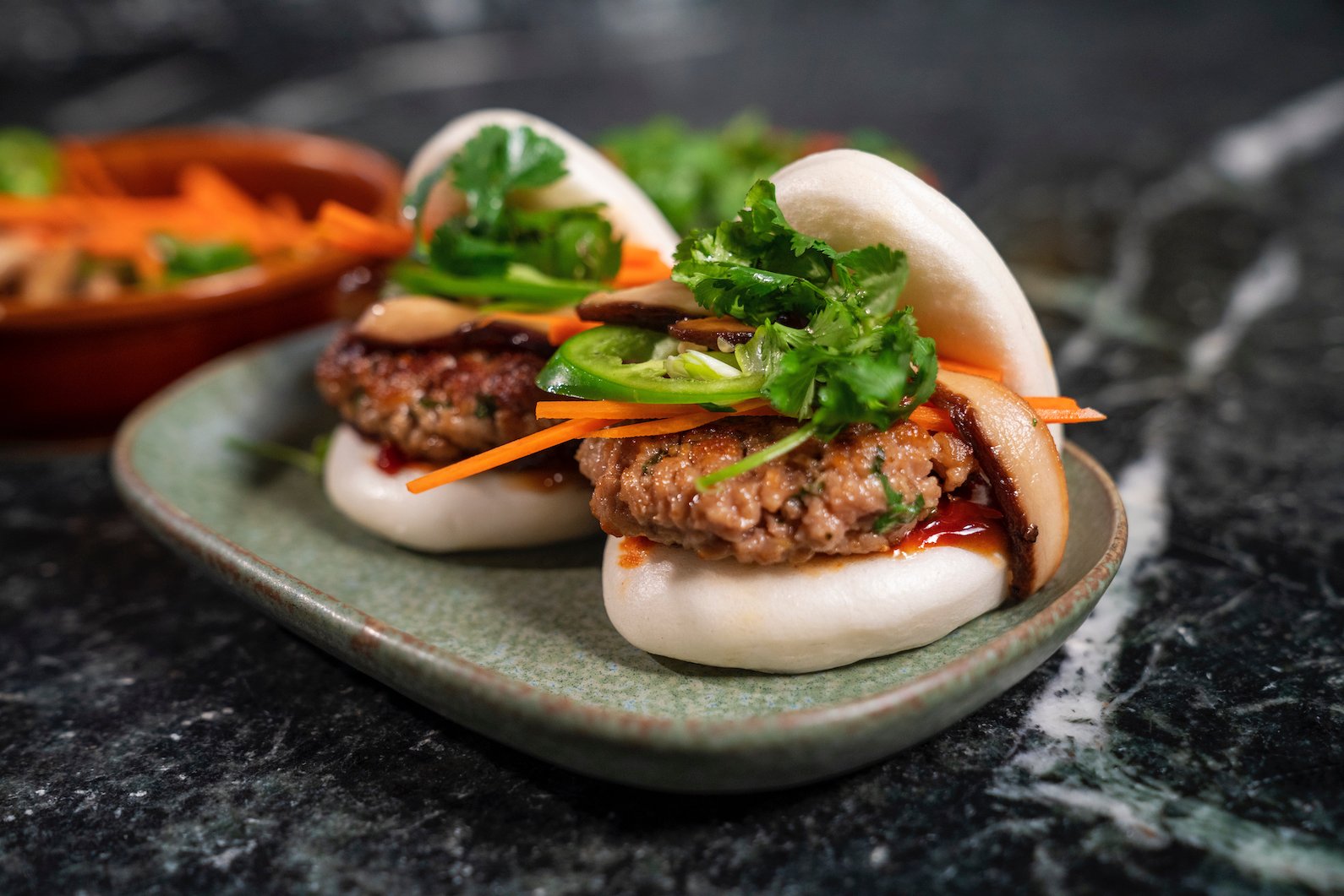 Close-up of 2 burgers on a plate