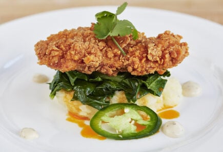 A battered and fried cultured meat, a cultured chicken cutlet, plated with sauteed greens and mashed root vegetables | Image courtesy of UPSIDE Foods