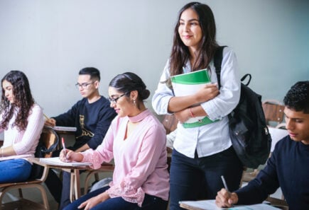 Smiling student with backpack and folder