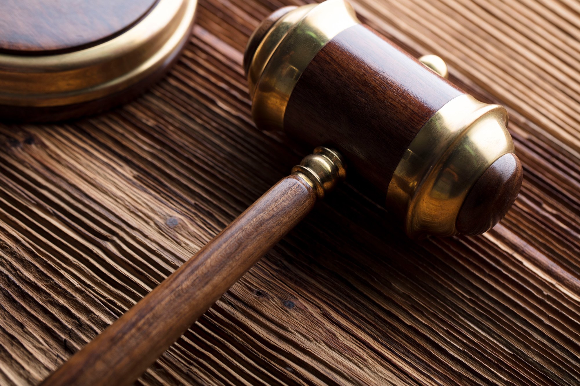 A close up of a gavel on a wooden desk, representing food policy concept