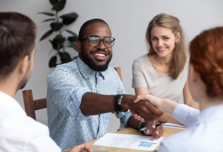 People shaking hands during a business meeting