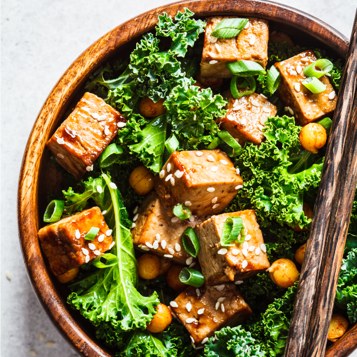 Plant-based retail market overview 25 A wooden bowl filled with a meal of fried tofu, kale, and chickpeas