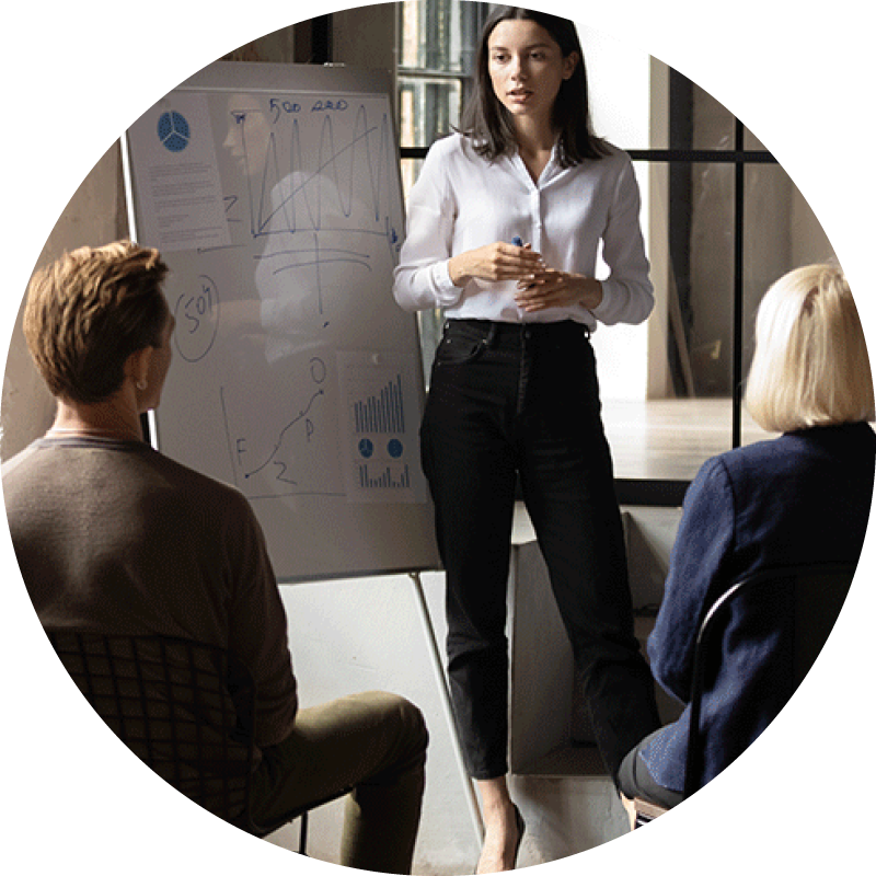 Confident woman presenting to a group of investors in an office conference room