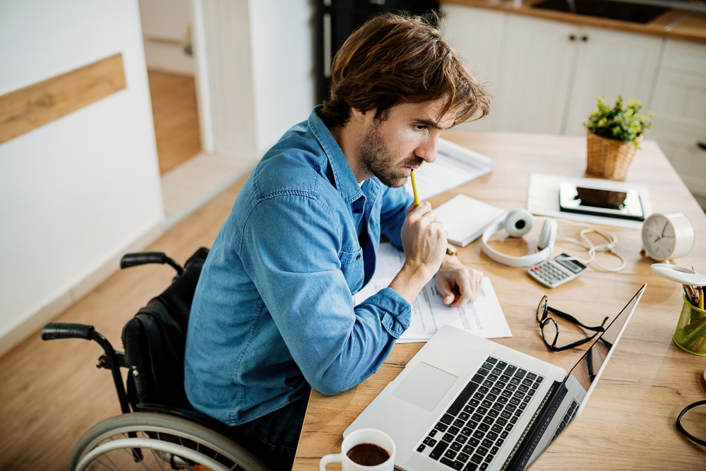 Portrait of a man reading an email while working from home