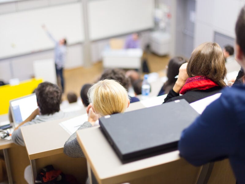 Speaker giving presentation in lecture hall at a university