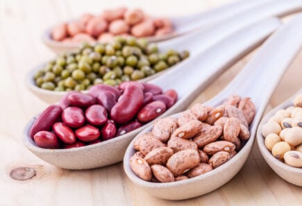 Assortment of beans and lentils in spoons