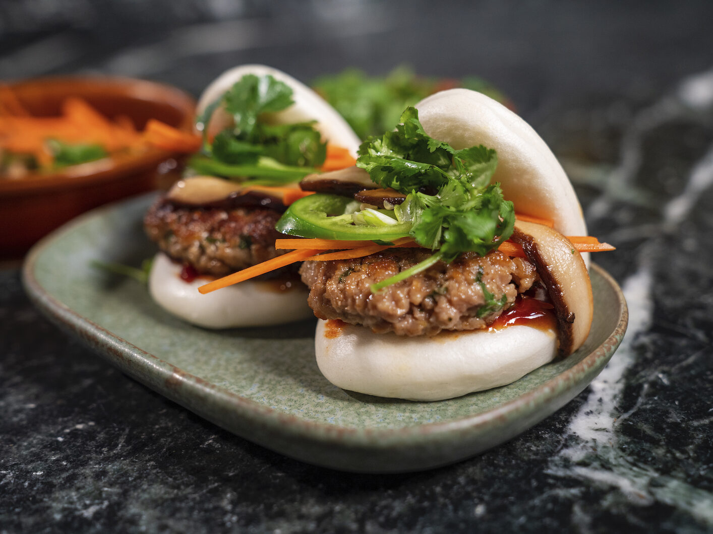 Close-up of 2 burgers on a plate