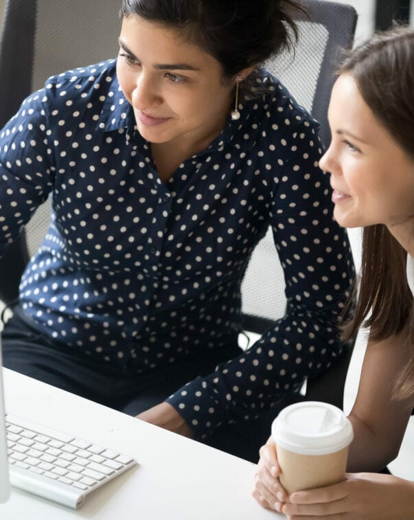 Two people looking at monitor together