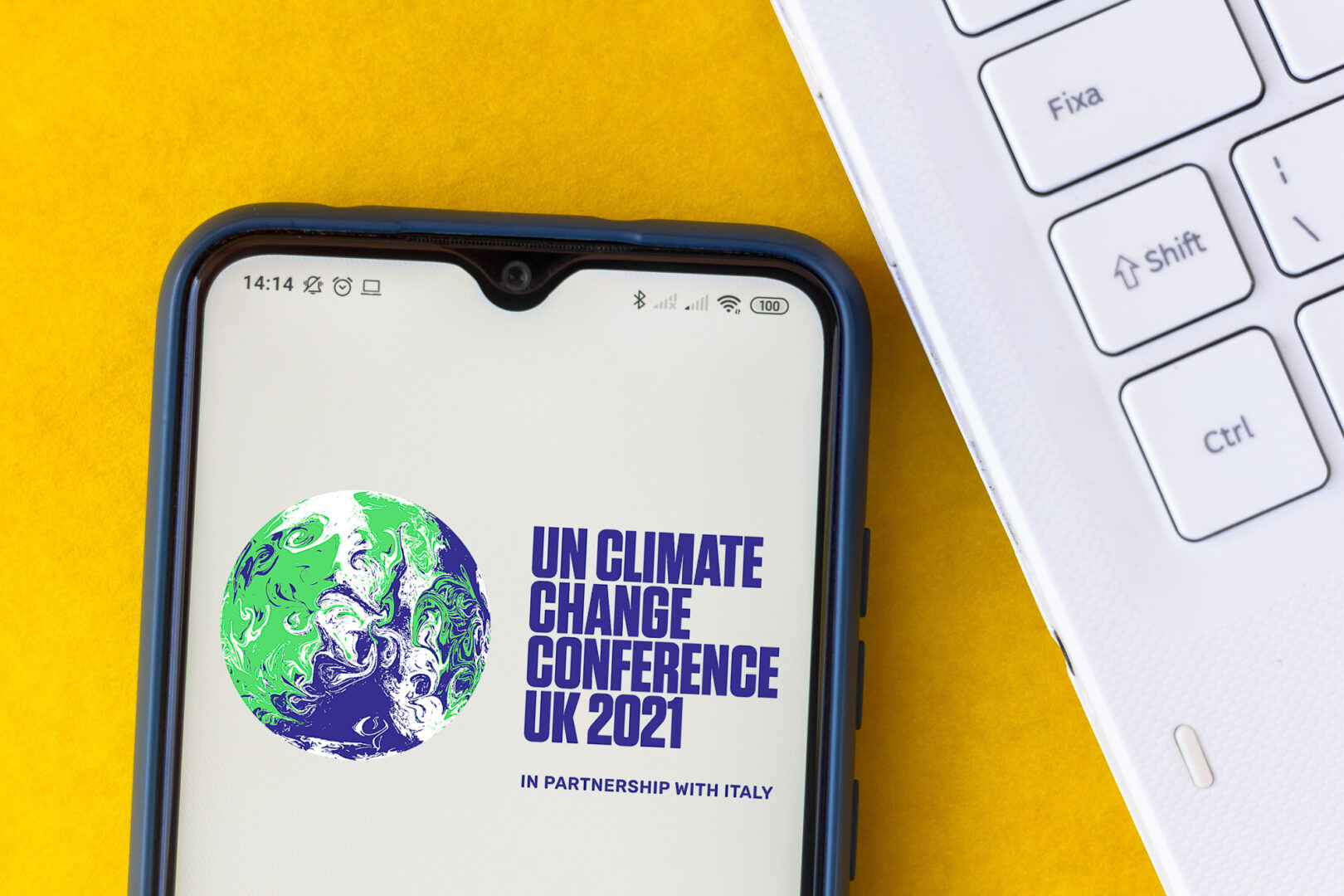 Illustration of the 2021 united nations climate change conference (cop26) logo seen displayed on a smartphone