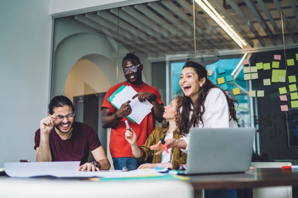 Group of students in a work room laughing