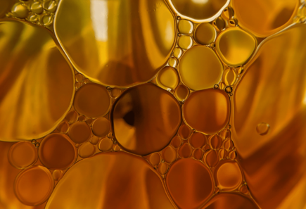 Macro of oil bubbles in water with a floral background