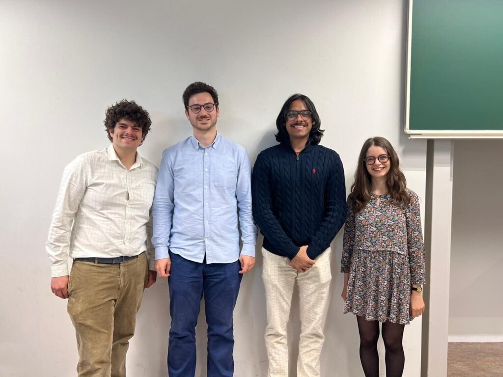Four students standing in a row