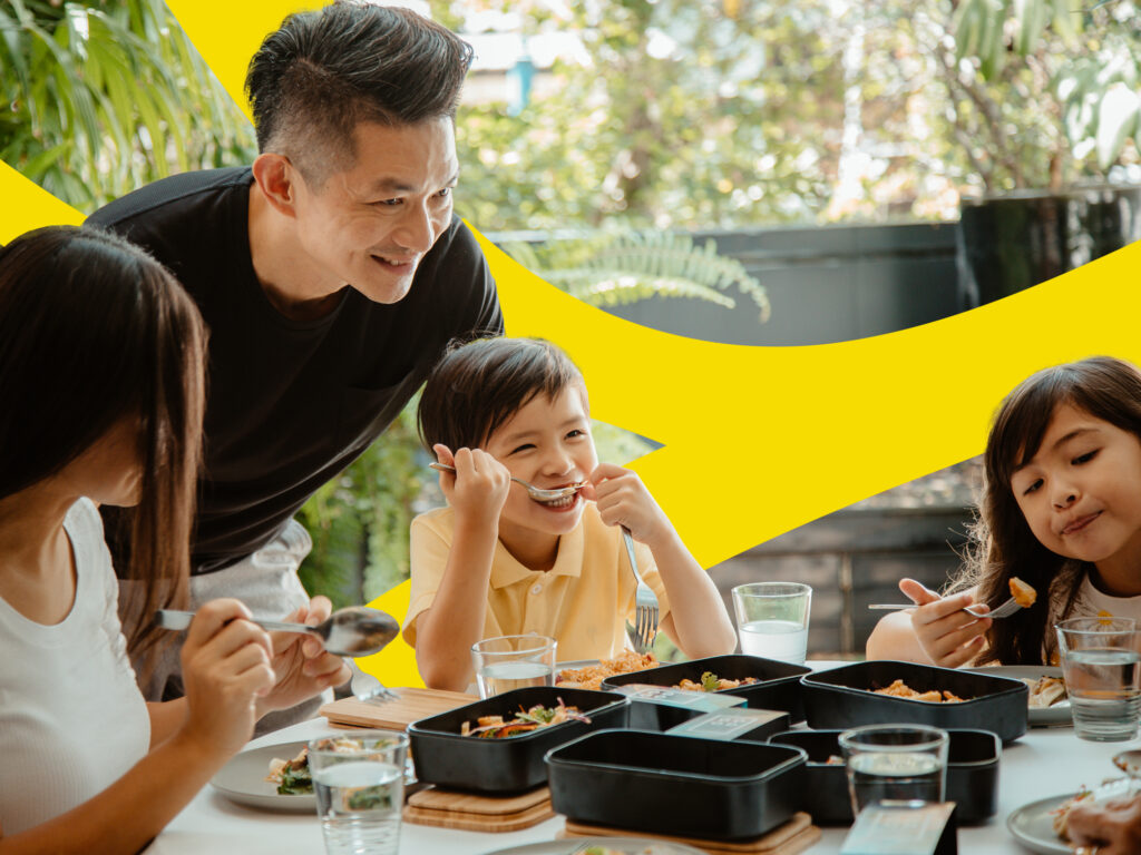 A parent and three children eat cultivated meat at home