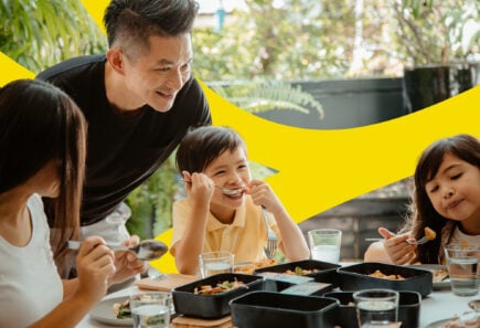 A parent and three children eat cultivated meat at home