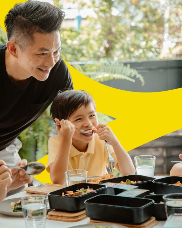 A parent and three children eat cultivated meat at home