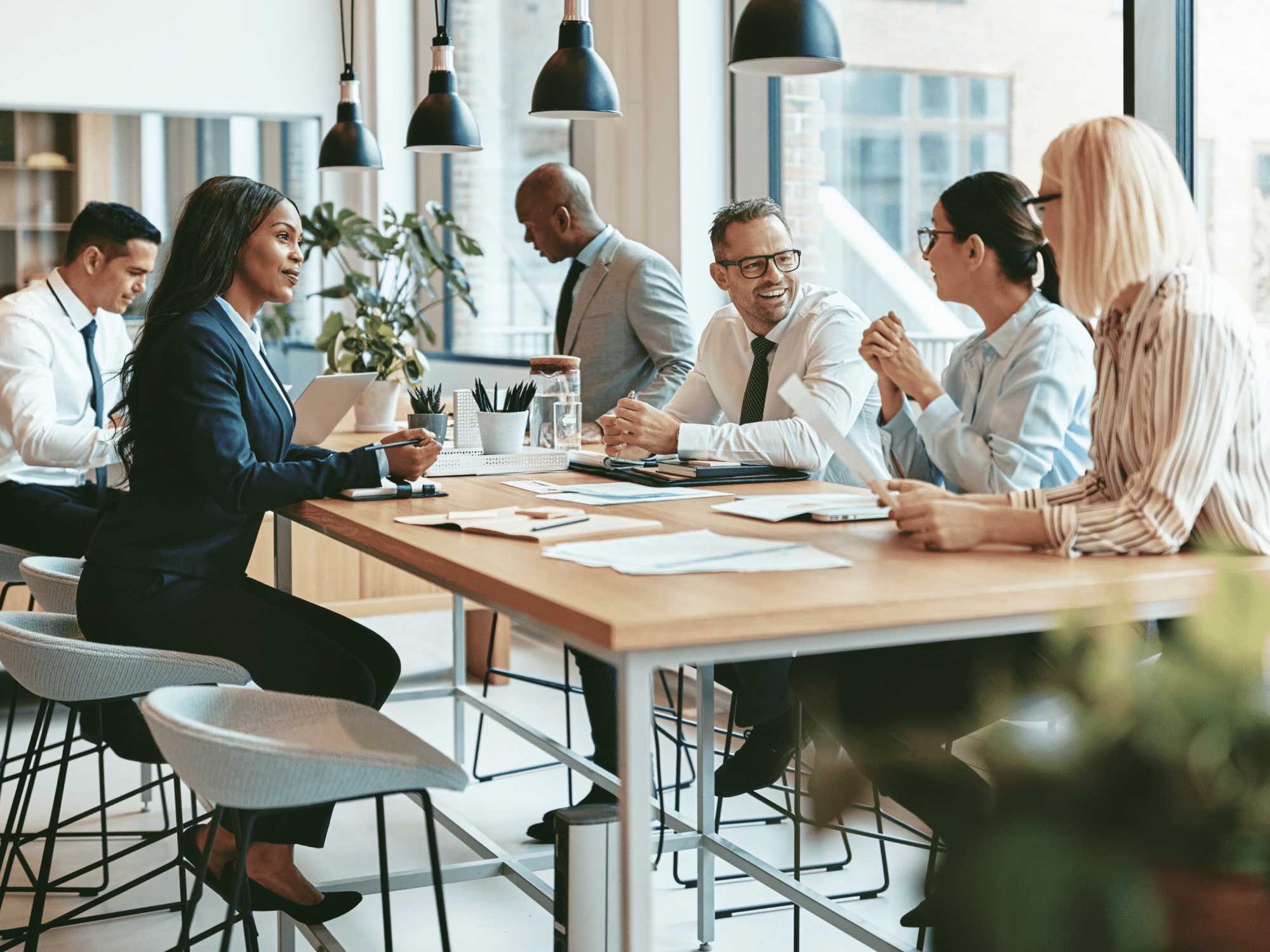 A photo of a group of professional people working at a table