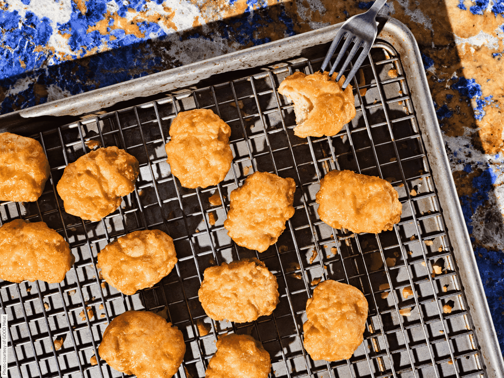 Photo of cultivated chicken nuggets on a baking tray from above