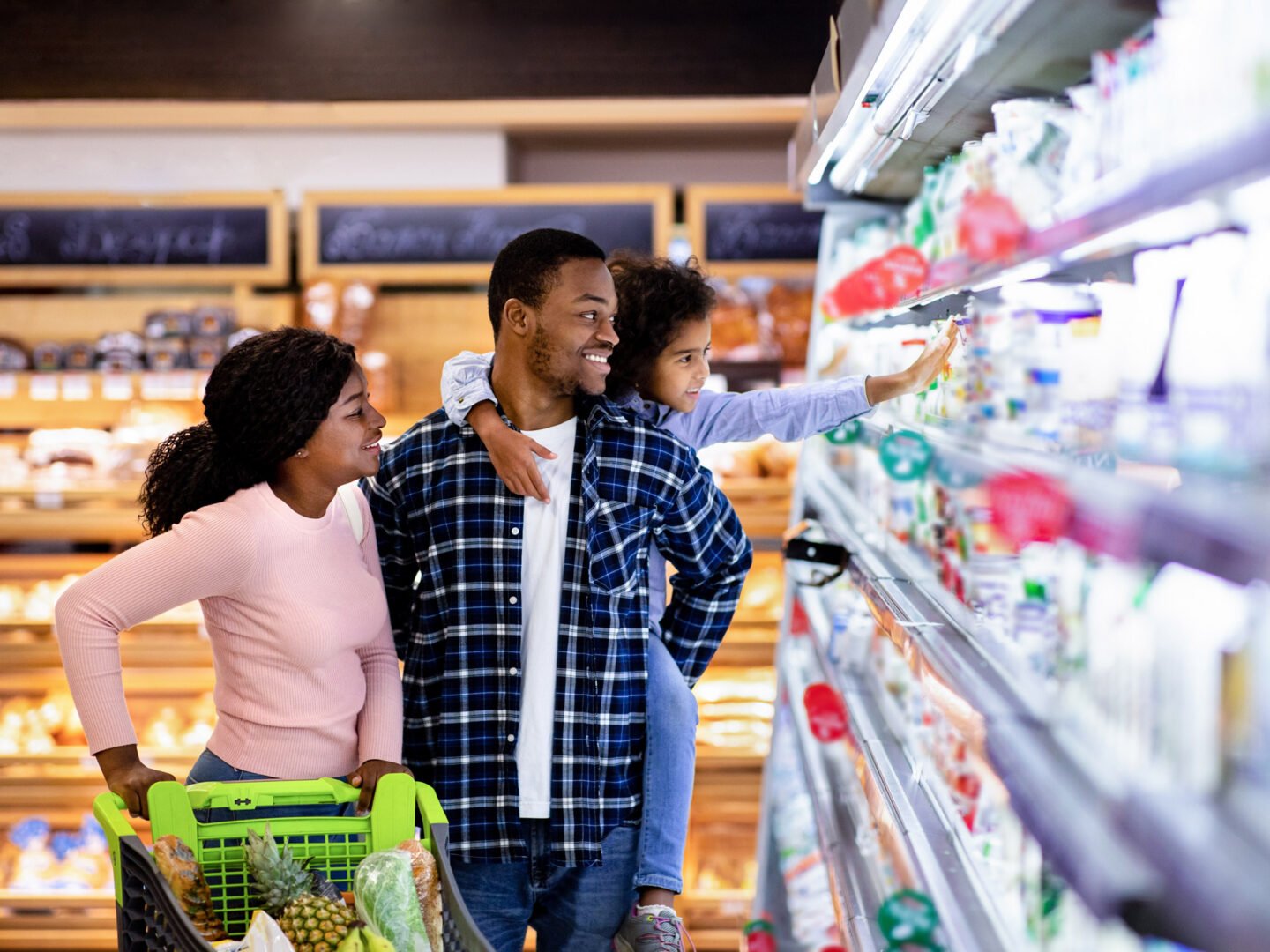 A photo of a family shopping at a grocery store