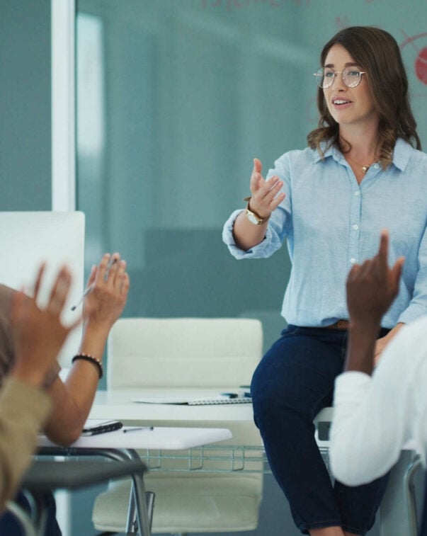 An educator speaks to students in a classroom