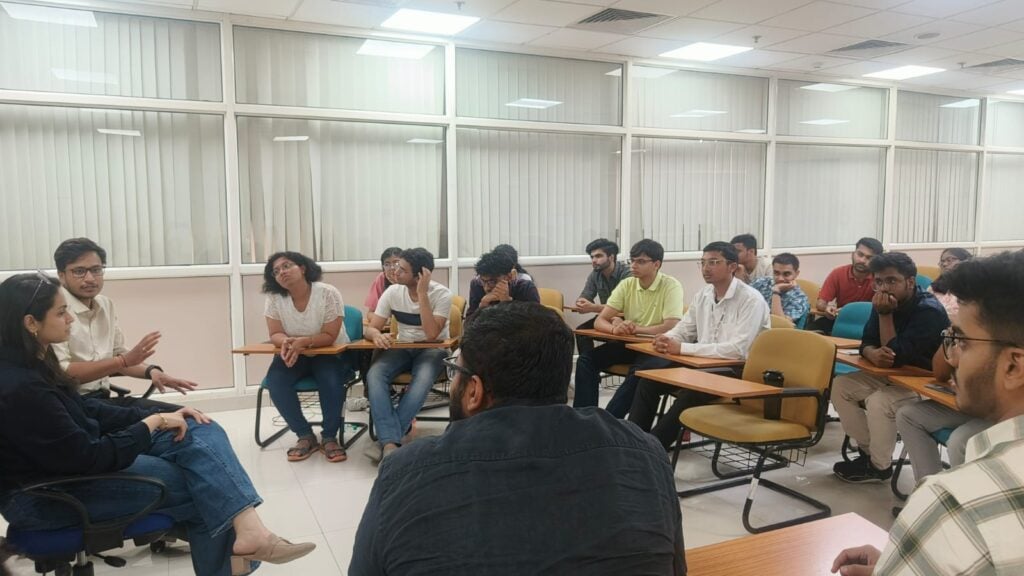 Rows of students listening to two speakers