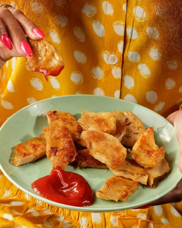 Consumer insights 2 A person holding a plate of plant-based chicken and ketchup