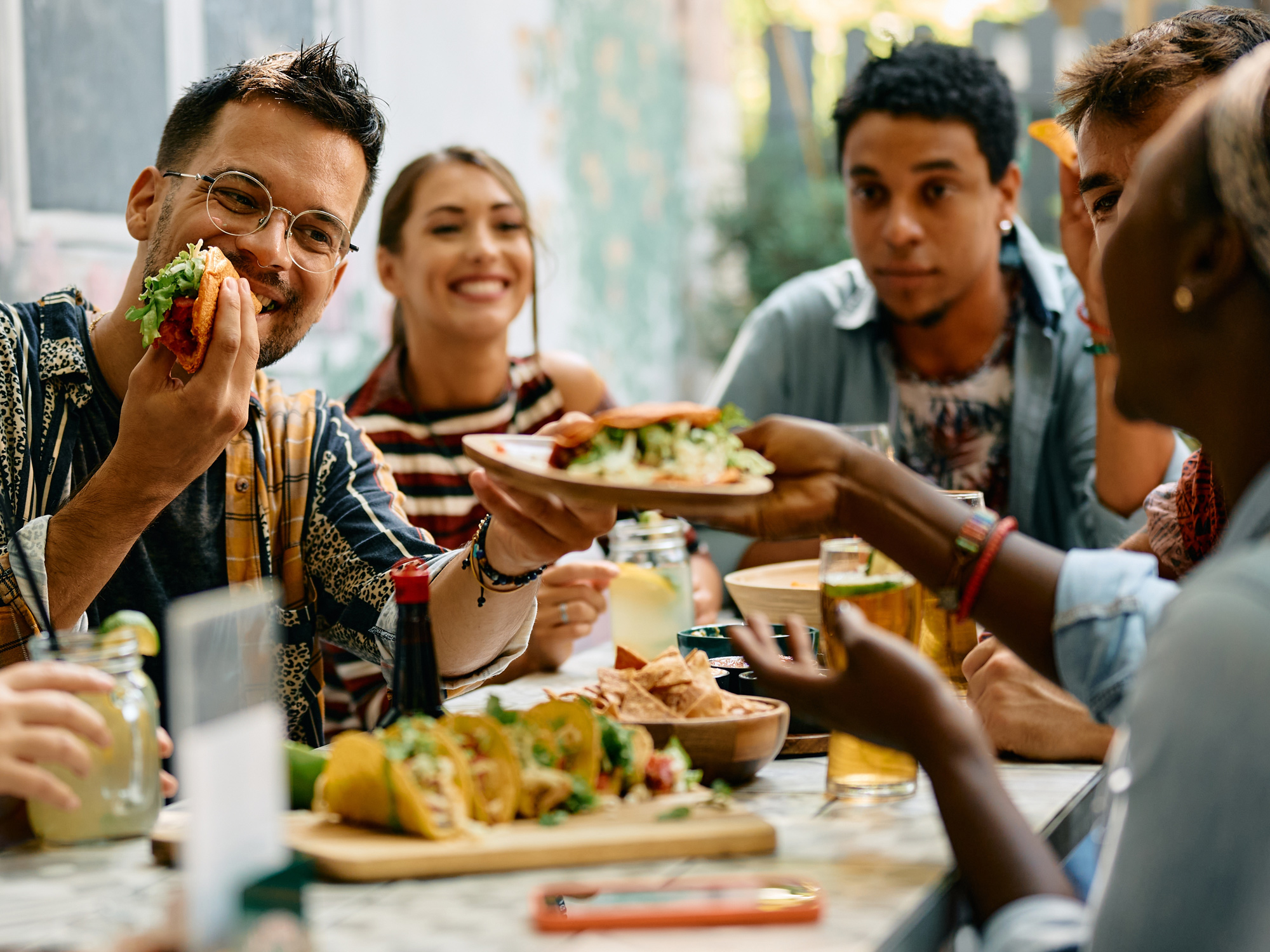 A group of people sitting and eating food at a table