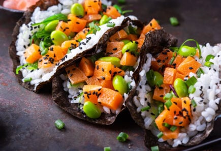 Salmon tacos with rice, edamame, and black sesame seeds