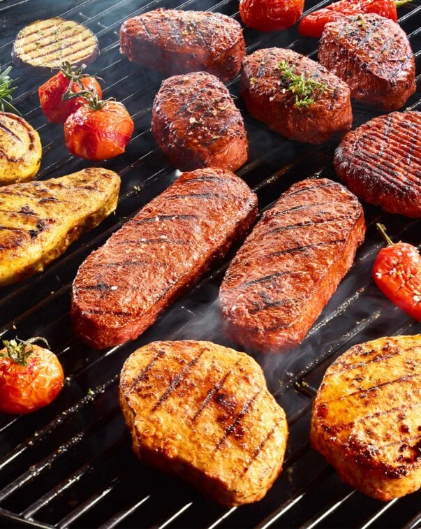 Manufacturing & production 4 Plant-based steaks, filets, chicken breasts cooking on a grill