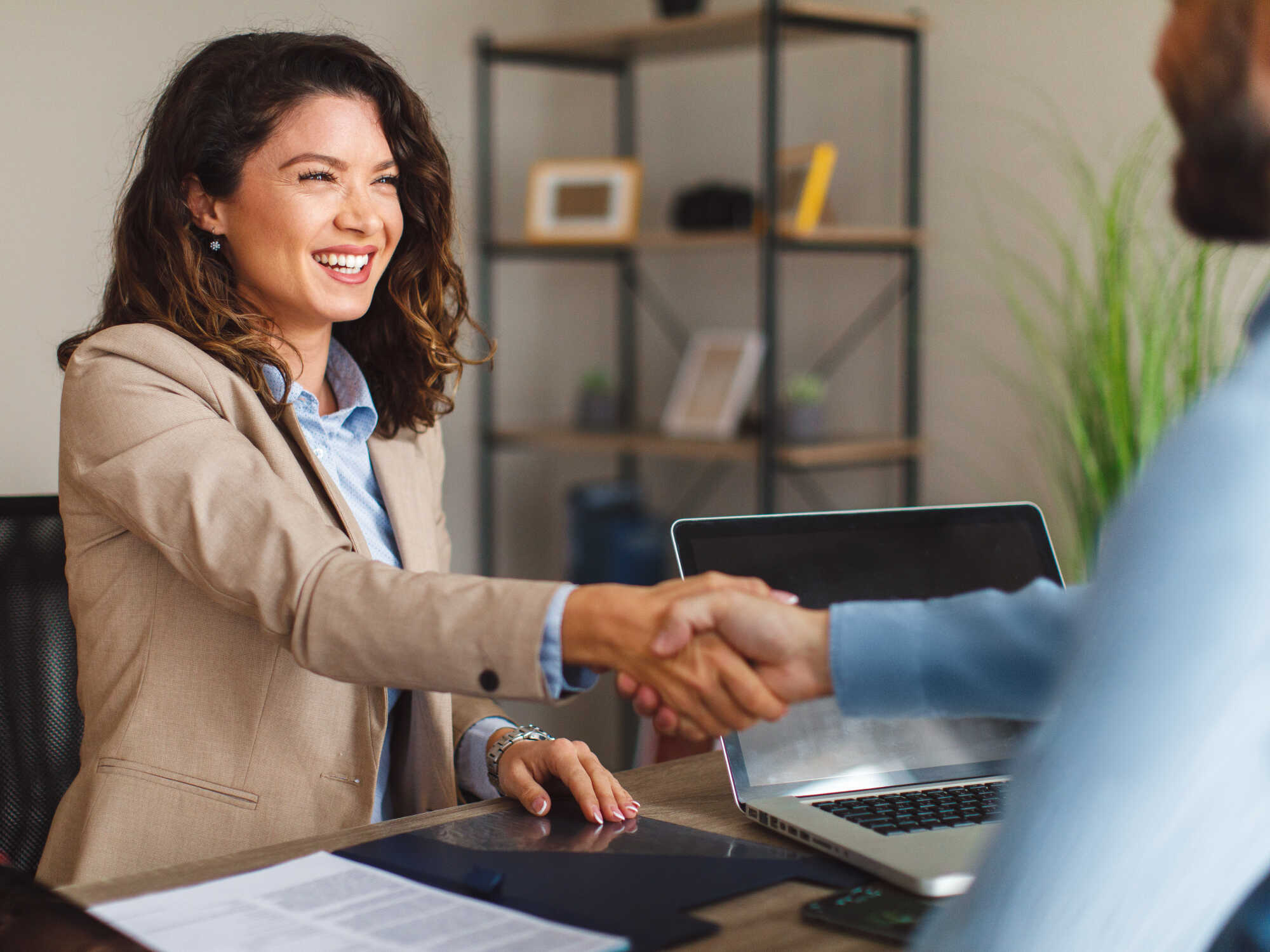 U. S. Loan and guarantee programs for scaling alternative proteins 1 Smiling woman in blazer shaking hands during a meeting