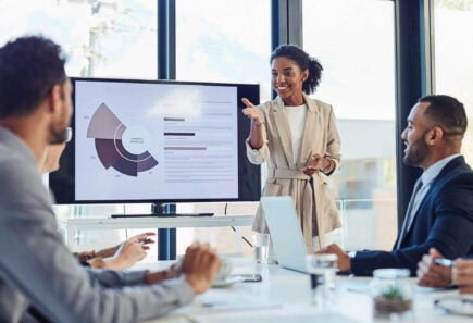 Businesswoman presenting data to colleagues in a meeting
