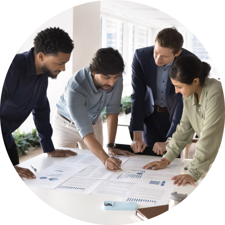 Give us feedback on our report 1 Team collaborating over documents on a table