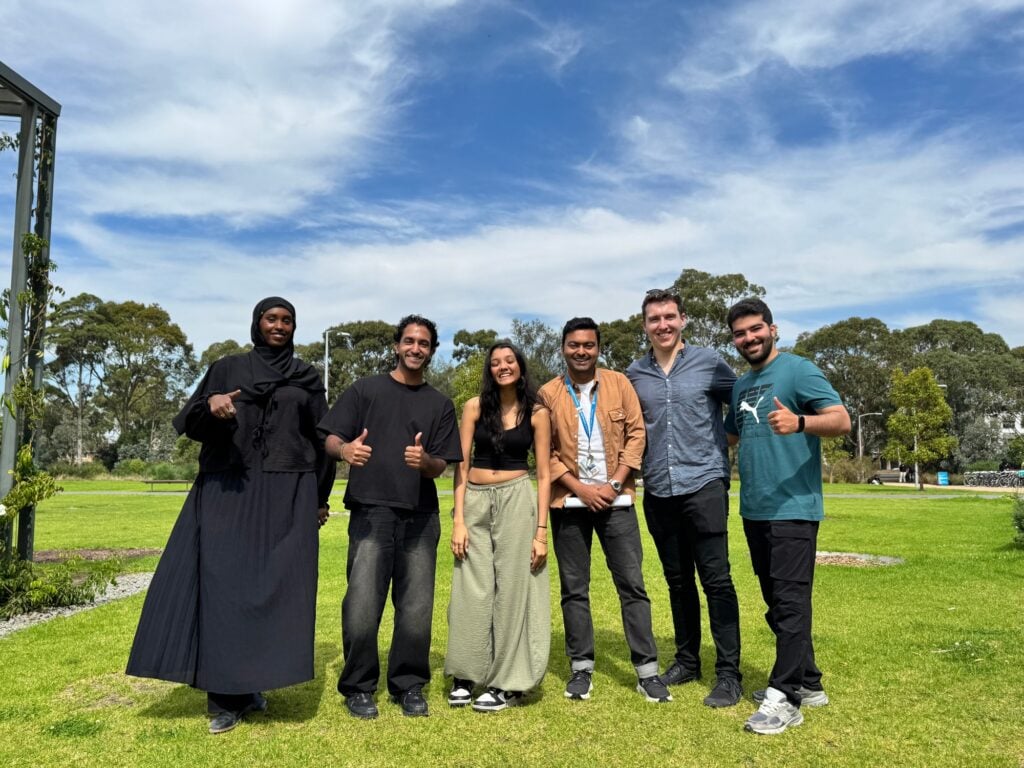 Six members of the Monash Alt Protein Project posing together outdoors on campus.