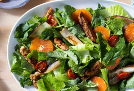 Bowl of salad with citrus and plant-based chicken