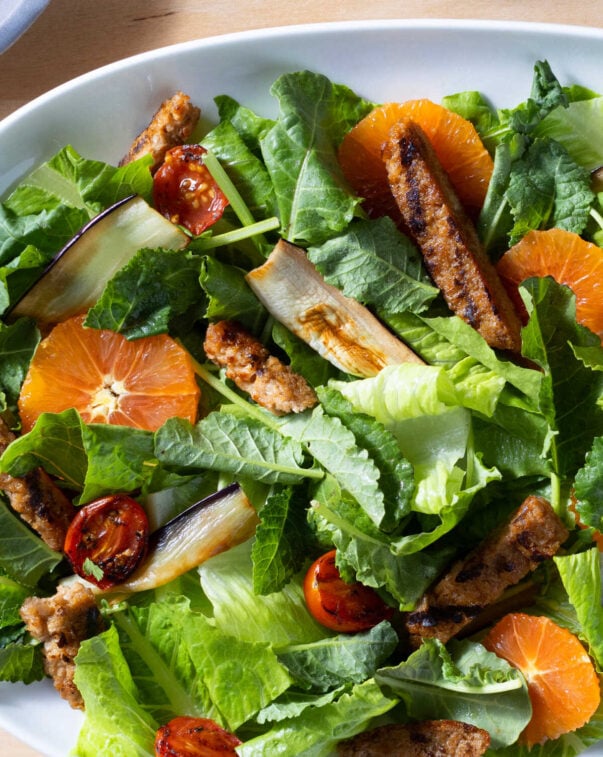 Bowl of salad with citrus and plant-based chicken