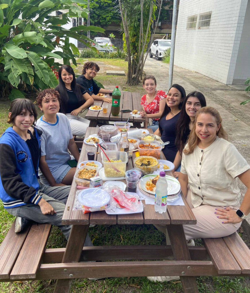 Members of the UFRPE Alt Protein Project sitting at a large table sharing plant-based lunch after a recent meeting.