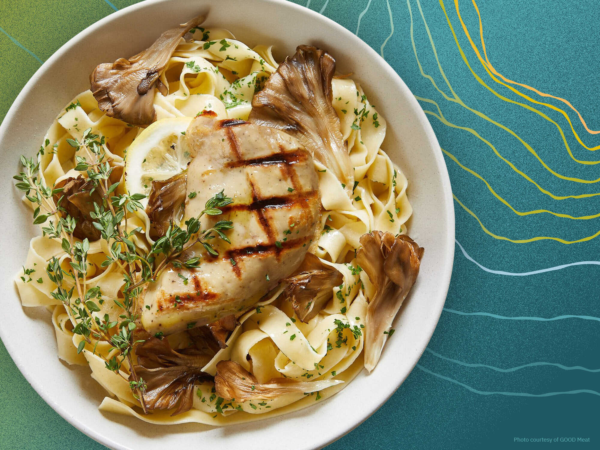 Plate of chicken with pasta and mushrooms on ripple background