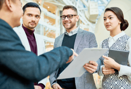 A group of people discussing business