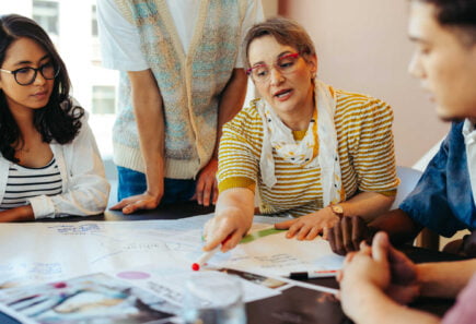 Diverse group working around a table together