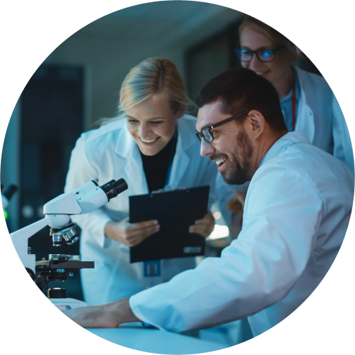 Research grants 4 A group of scientists looking at a microscope in a lab