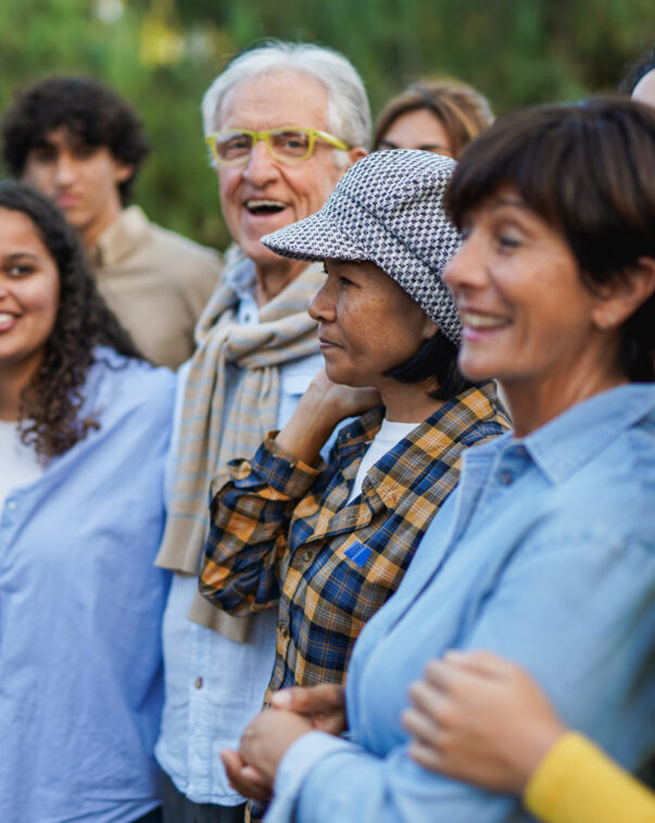 Diverse group of people standing in line and smiling