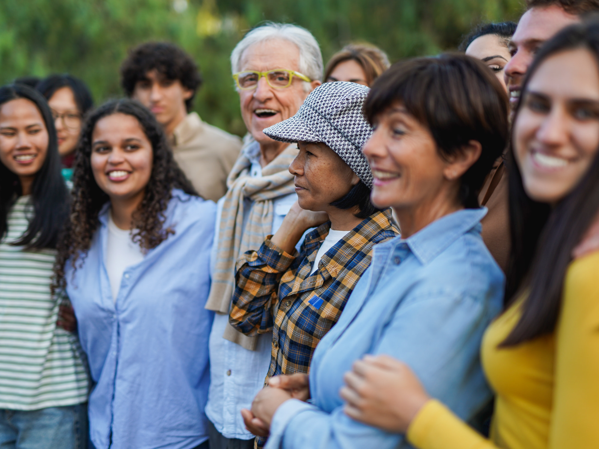 Diverse group of people standing in line and smiling