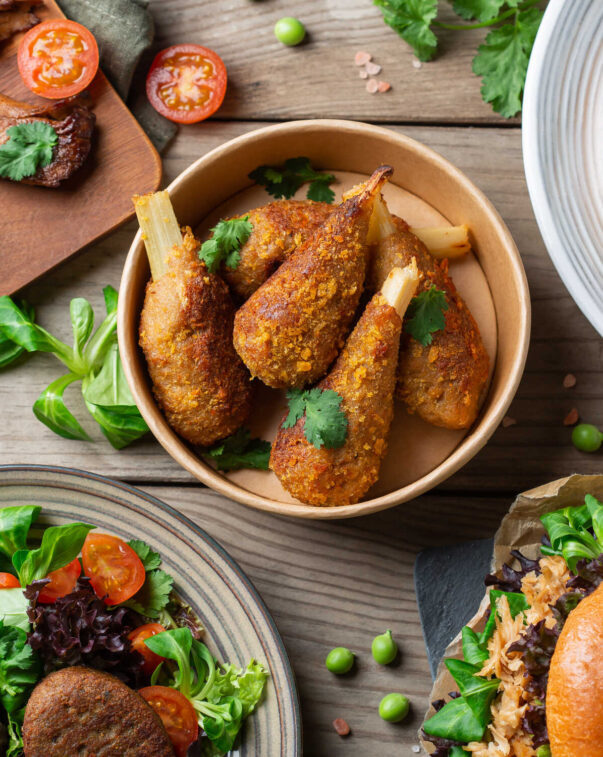 Top down view of a variety of plant based food and condiments on a table