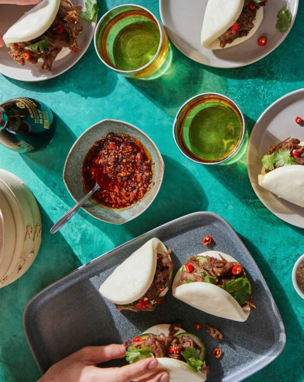 Top down view of plant-based bao buns and spicy condiments