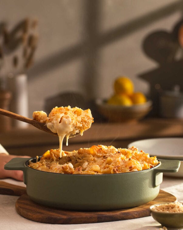 Steaming and gooey scoop of plant-baed macaroni and cheese over a skillet
