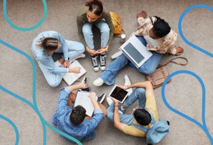 A group of students sitting together working on laptops